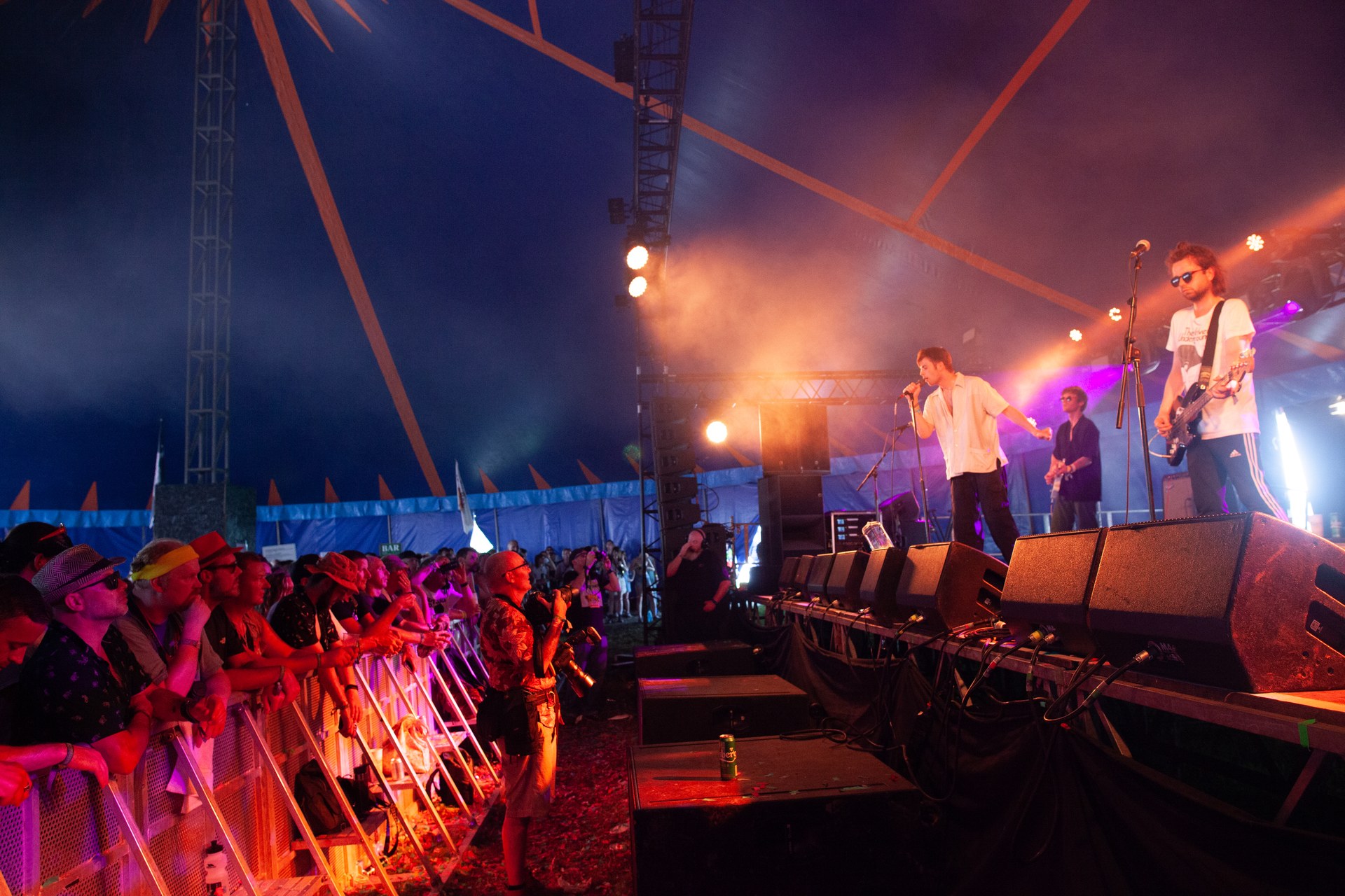 Fontaines D.C. on a festival stage at night, crowd pressed against the barrier